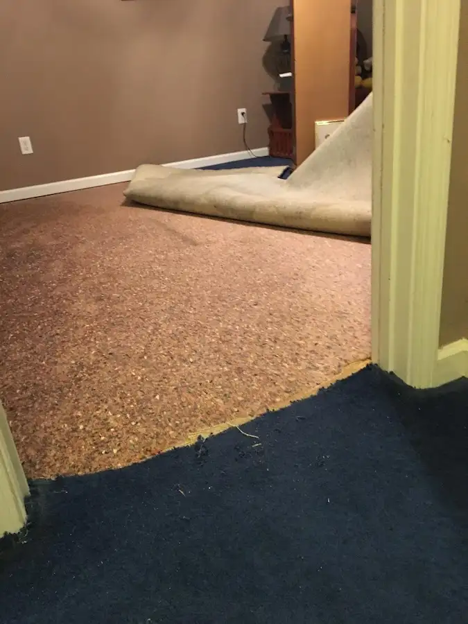 Carpet pad removal revealing water damage during Drying & Dehumidification in Wake Village